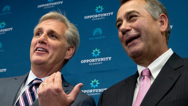 House Majority Leader Kevin McCarthy of California gestures toward outgoing House Speaker John Boehner of Ohio during a news conference in Washington Tuesday, Sept. 29, 2015.