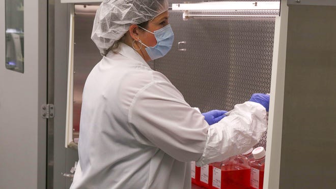 Sarah Layton, a production associate at Harrisvaccines, performs cell cultures on an Avian Flu vaccine on Thursday, Oct. 22, 2015, in Ames, Iowa.