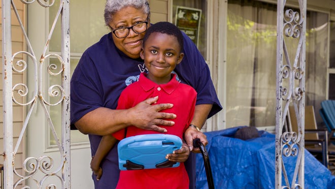 Rafel Marizetts, 6, stands wrapped in the arms of his mother, Idella Marizetts, 73, at their home on W. Harvard Ave. in Peoria Thursday, July 16, 2020. Idella Marizetts has leukemia and has decided not to send Rafel, who she adopted when he was 5 days old, to school in the fall because of the risks of COVID-19 exposure for both of them. The decision to allow children to return to school is especially difficult for older caregivers who are more susceptible to COVID-19.