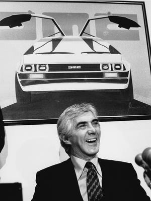 John DeLorean answers reporters' questions at a news conference in New York on Feb. 19, 1982. DeLorean developed the short-lived gull-winged sports cars featured as a souped-up time travel machine in the "Back to the Future" movies