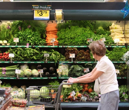 An Indiana resident shopping for organic food. MICHELLE PEMBERTON, THE INDIANAPOLIS STAR