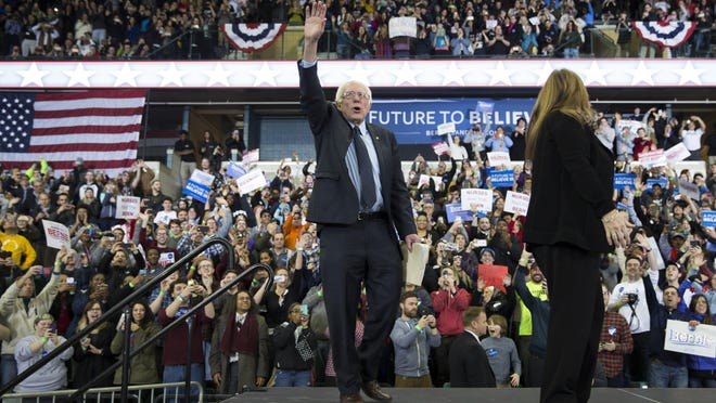 Jane Sanders, right, and her husband Democratic presidential candidate Sen. Bernie Sanders, I-Vt., arrive for a rally at Eastern Michigan University on Monday in Ypsilanti.