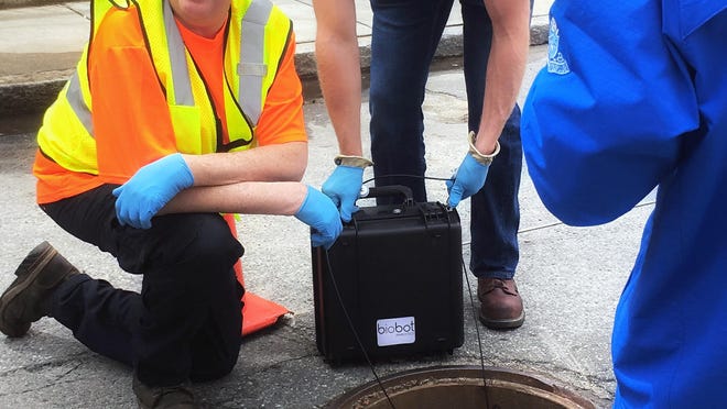 In this undated photo provided by Biobot in June 2020 technicians take a sewage sample. Across the U.S. and in Europe, researchers and health officials say they can track the course of a community outbreak by studying the waste flushed from its bathrooms. And that can provide a valuable addition to public health tools, they say.