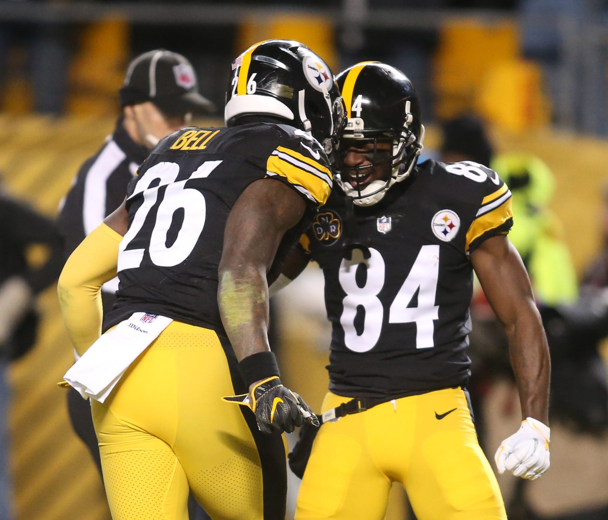 Pittsburgh Steelers running back Le'Veon Bell (26) celebrates with wide receiver Antonio Brown (84) after scoring a touchdown against the Baltimore Ravens during the first quarter at Heinz Field.