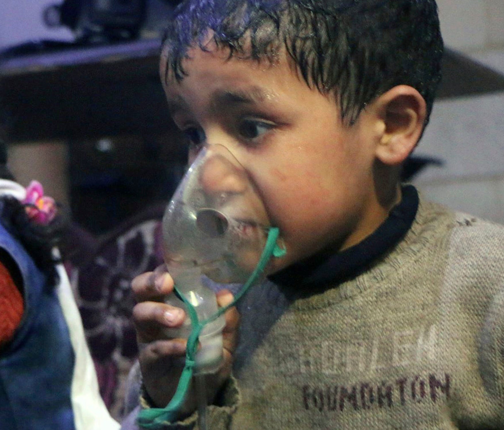 This image released early April 8, 2018 by the Syrian Civil Defense White Helmets, shows a child receiving oxygen through respirators following an alleged poison gas attack in the rebel-held town of Douma, near Damascus, Syria. Syrian rescuers and me