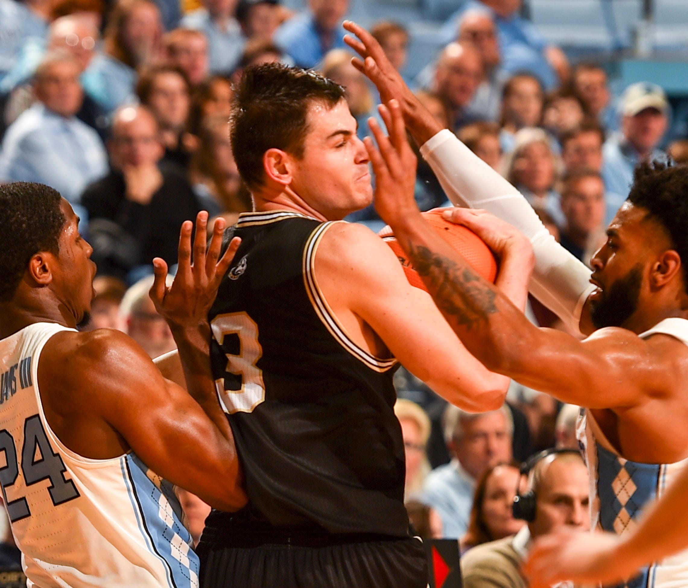 Wofford guard Fletcher Magee is defended by North Carolina guards Kenny Williams, left, and Joel Berry II, right, during the first half at Dean E. Smith Center in Chapel Hill, N.C.