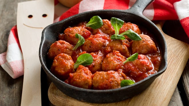 Meatballs with tomato sauce in pan, selective focus