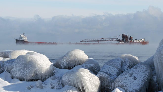 “Winter Arrival in Marquette,” by Rod Burdick. When the Laker Kaye E. Barker arrived at Presque Isle Harbor, Marquette, on a frigid December morning, “The sea smoke on Lake Superior and iced-over rocks on the lakeshore caught my eye,” he said.