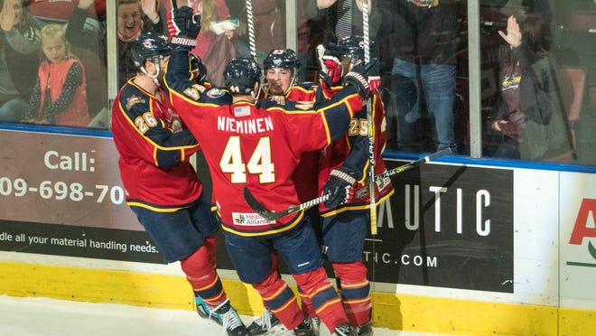 Peoria Rivermen rookie winger Ryan Cusin (against the glass) celebrates his dramatic game-tying goal with 76 seconds left during Peoria's 3-2 sudden-death shootout win over Roanoke at Carver Arena on Sunday, March 8, 2020.