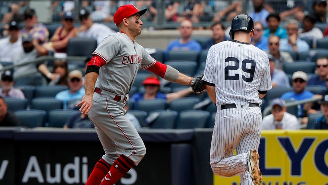 Cincinnati Reds first baseman Joey Votto tags out New York Yankees' Todd Frazier (29) after coming off the bag to take the throw during the fifth inning of a baseball game, Wednesday, July 26, 2017, in New York.