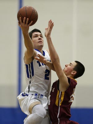 Wrightstown’s Stephen De Cramer (2) goes up for a shot over Luxemburg-Casco’s Bryce Te Kulve during Tuesday’s game in Wrightstown.