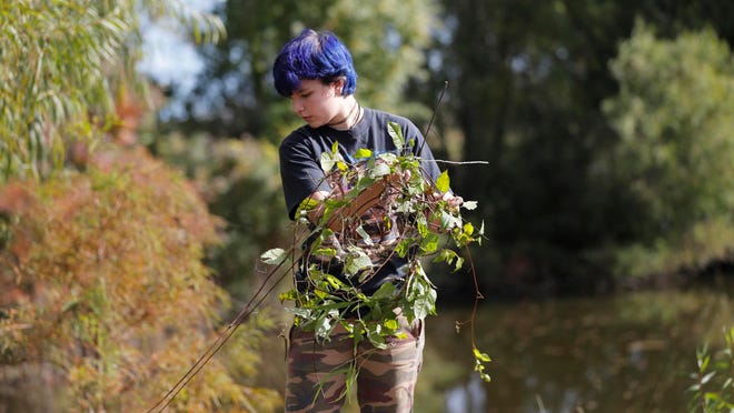 Vera Scarpulla, a student from New Harmony High School, works on a restoration project at the Sankofa Wetland Park and Nature Trail in New Orleans’ Lower 9th Ward neighborhood.