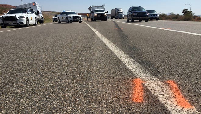 Utah Highway Patrol troopers investigate the scene on Interstate 15 near Exit 13 where a man was found in very critical condition lying in the southbound lanes of the freeway Tuesday, Aug. 18, 2015.