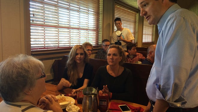 Texas Sen. Ted Cruz visits the table of Cherly Hetrick, 49, of Des Moines (middle) and talks about his recent CNN debate performance.