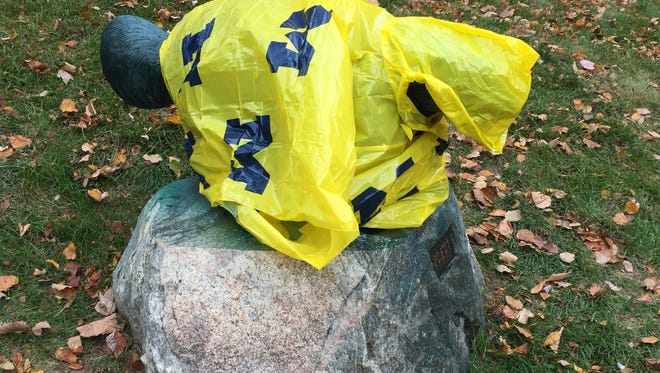 After being painted, the wolverine statue was wearing a poncho Friday, Oct. 16, 2015.