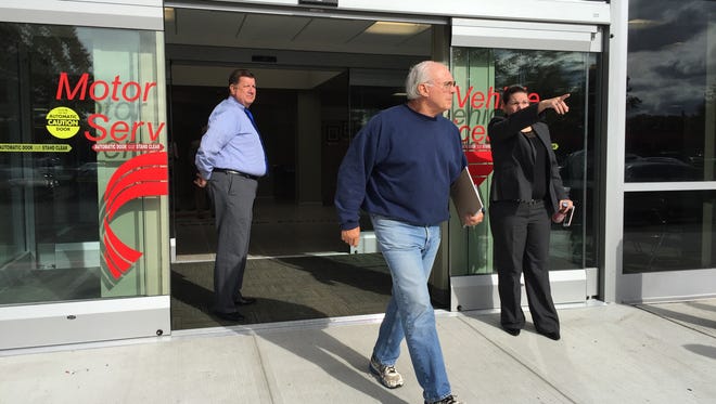 A customer exits the newly renovated Motor Vehicle Service's building in Eatontown on Tuesday.