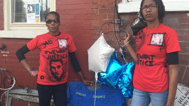 Phyllis McDole, the mother of Jeremy "Bam" McDole, and her daughter Keandra McDole stand near a makeshift memorial  to their brother and son.
McDole was shot and killed by police last month.