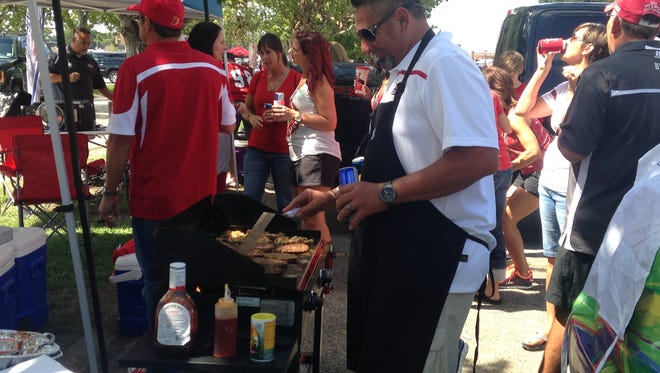 Darren Menard, aka Chef D, grills burgers on Sept. 12 outside Cajun Field. Menard cooks every home game for the Digitech tailgate group.