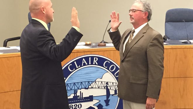 St. Clair County Clerk Jay DeBoyer swears in Duke Dunn to fill the vacated 4th District commissioner seat on Thursday, Nov. 5.