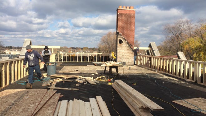 A construction crew repairs and reinforces the roof of the Sisters of the Holy Nativity Convent on Nov. 7, 2015. A fire on June 5 caused major damage to the Fond du Lac historic landmark.