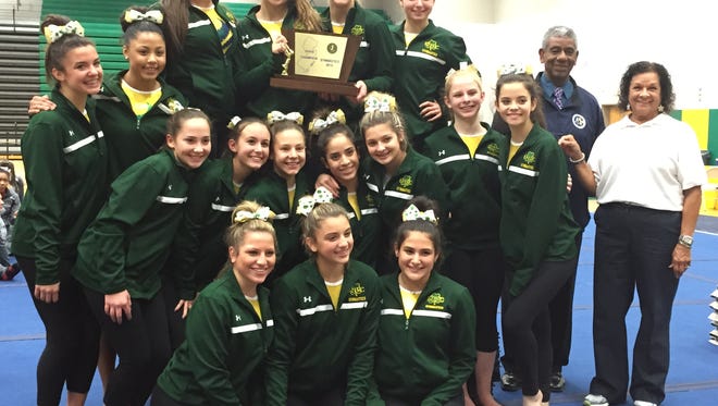 Red Bank Catholic poses with the NJSIAA gymnastics team trophy.