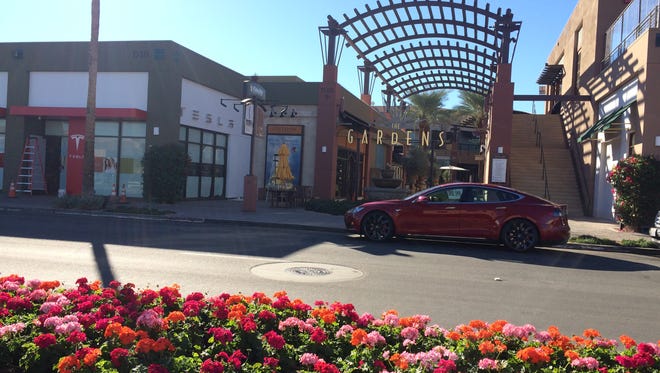 A Tesla Model S is parked in front of a new showroom, set to open Black Friday at The Gardens on El Paseo in Palm Desert.