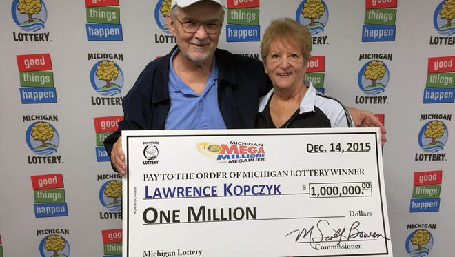 Lawrence Kopczyk poses for a photo with his wife, Pat, after collecting a $1 million Mega Millions prize.