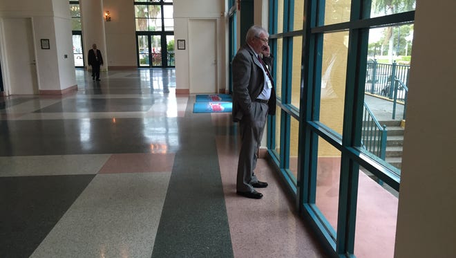 Next big deal? An attendee at CCIM's 2016 Commercial Real Estate Outlook Conference steps out for a phone call Thursday morning at Harborside Event Center in downtown Fort Myers.