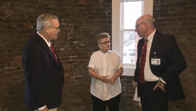 Dr. John Fortney, left, talks with Imogene Overly, a caregiver with Adena Health System, and Mark Shuter, Adena CEO, during a recent tour of the Carlisle Building for Overly, who once owned a business in downtown Chillicothe.