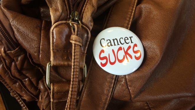 A button on Jennifer Holm's purse speaks to how she feels about her condition.