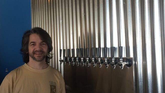 Anthony Abate stands before the 12 taps that will soon dispense Devil's Creek beer in Collingswood.