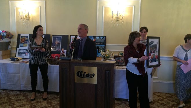 Steven Chickery, a Grace Smith board member, acts as auctioneer during Grace Smith House's annual spring brunch and auction Sunday at Christos Catering in Poughkeepsie.