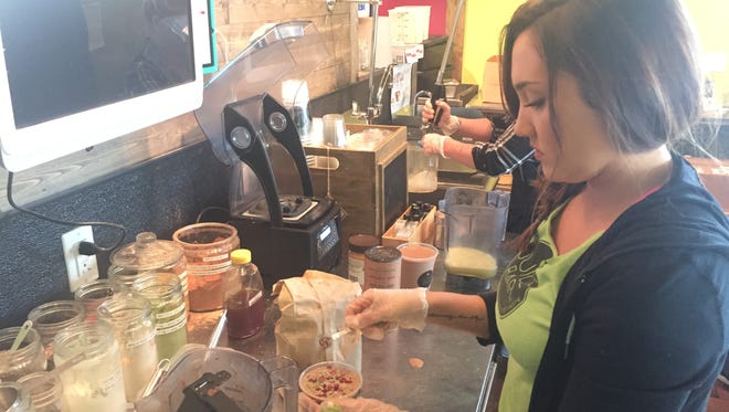 Myka Campbell makes a smoothie at The Juice Bar.