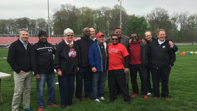 Coaches and athletes who competed on the 1983 boys track team at Harding reunited Friday night at the Marion Night Invitational to honor their Class AAA state championship. Head coach Rick Huddle of that squad is in the red hat.
