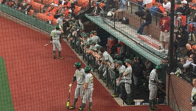 Oregon players outside the du dugout before Game 1 of the Civil War series Friday at Goss Stadium in Corvallis.