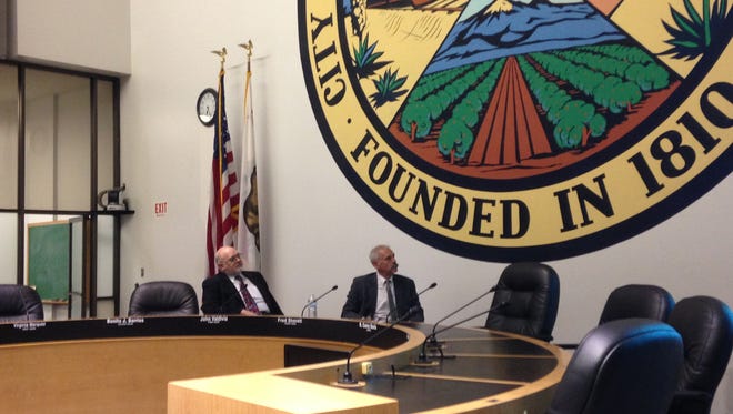 California Public Utilities Commission President Michael Picker (right) and commission member Mike Florio watch a presentation during a public forum at San Bernardino City Hall on May 31, 2016.