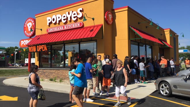 Dozens of people line up for Popeyes grand opening Thursday.