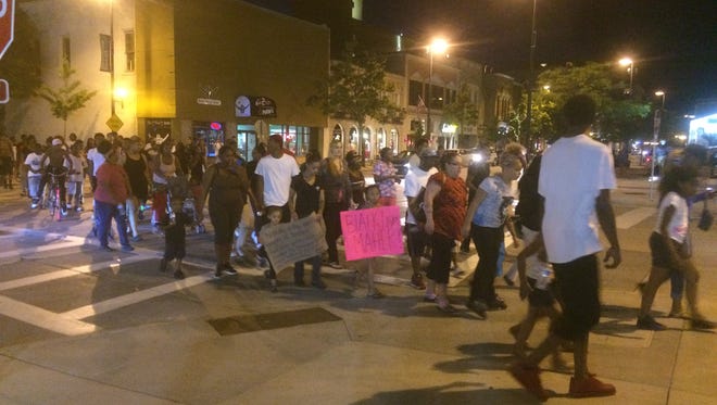 About 100 people marched through downtown Green Bay in support of the Black Lives Matter movement on Tuesday, July 12, 2016.