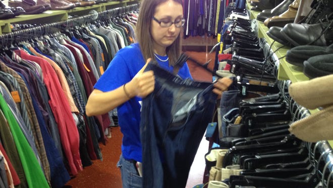 Erica Simonian, a staff assistant in TCC department of Communications and Humanities, practices the art of keeping clothing items neat while volunteering at Goodwill Industries Wednesday.