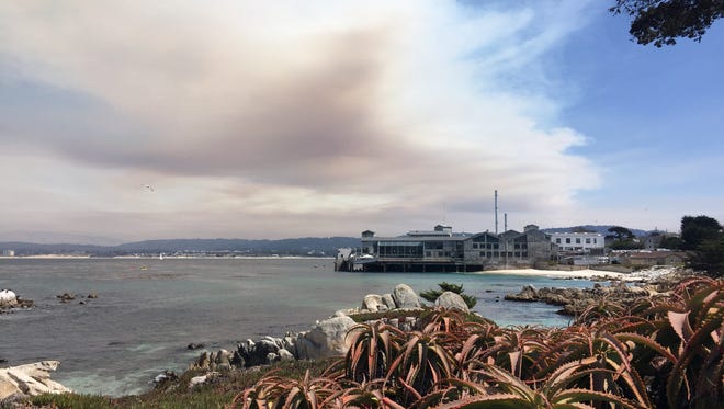 Smoke from the Soberanes Wild Fire rises above the Monterey Bay Aquarium on Thursday, July 28, 2016