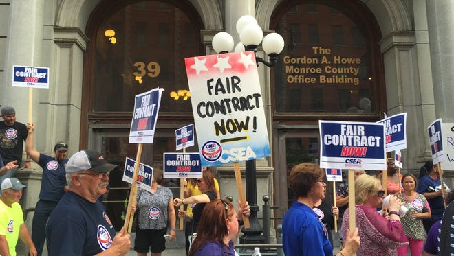Roughly 200 people demonstrated outside the Monroe County Office Building in Rochester in August 2016 calling for contracts for county workers.