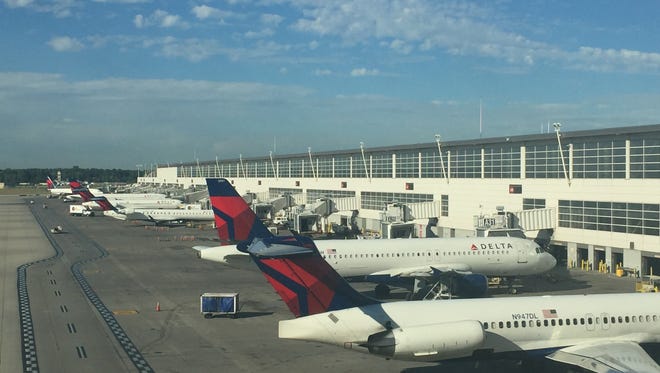 Delta jets sit at a gate at Detroit Metro Airport on Monday, Aug. 8.