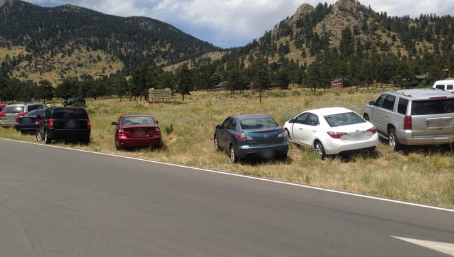 Illegally parked cars near the Beaver Meadows Visitor Center at Rocky Mountain National Park on July 25.
