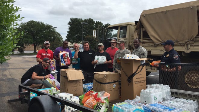 Supplies collected by The Daily Advertiser are loaded onto National Guard trucks stationed at Barnes and Noble to be distributed in flooded areas.
