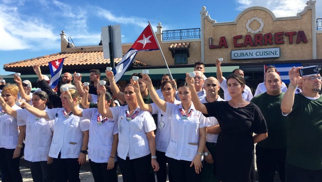 Employees of La Carreta, a Cuban restaurant frequented by Jose Fernandez, pay tribute to the fallen pitcher by raising cups of Cuban coffee.