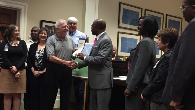 Mayor Johnny DuPree presents a proclamation to the city's planning department during Tuesday's meeting of Hattiesburg City Council.