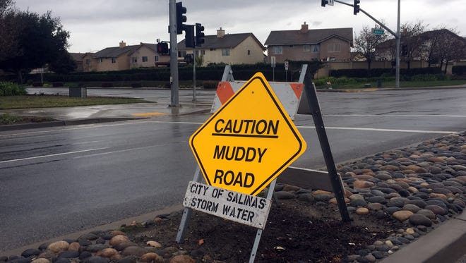 Signage warns of hazardous driving conditions on Williams Rd. in Salinas during weekend storms. 