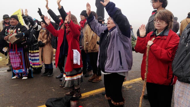 In this Oct. 26, 2016, file photo, protesters against the construction of the Dakota Access oil pipeline block a highway in near Cannon Ball, N.D. Environmental groups say they're prepared to keep up their court battle against the pipeline, after President Donald Trump moved to advance that stalled project as well as the Keystone XL pipeline.
