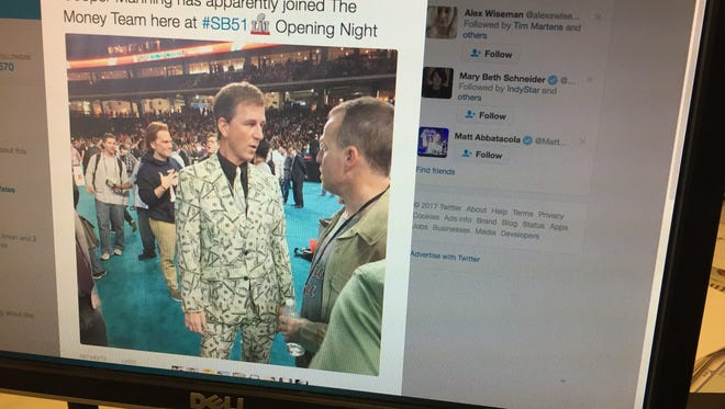 This image, posted by the Houston Chronicles' Matt Young, shows Cooper Manning wearing a money suit.