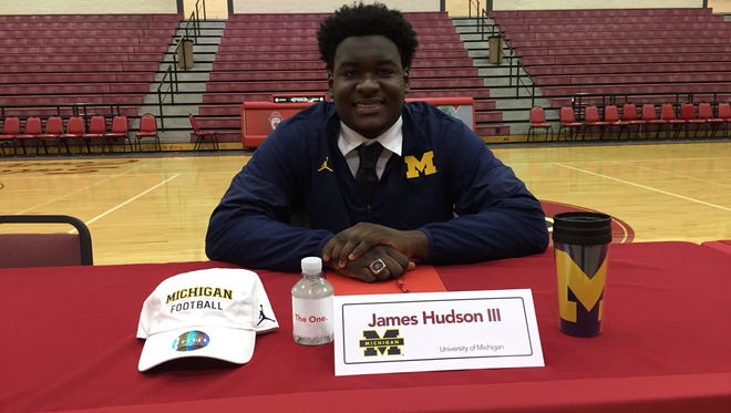 Toledo Central Catholic senior defensive lineman James Hudson III signs to play football at Michigan during a ceremony at his high school on Wednesday morning.